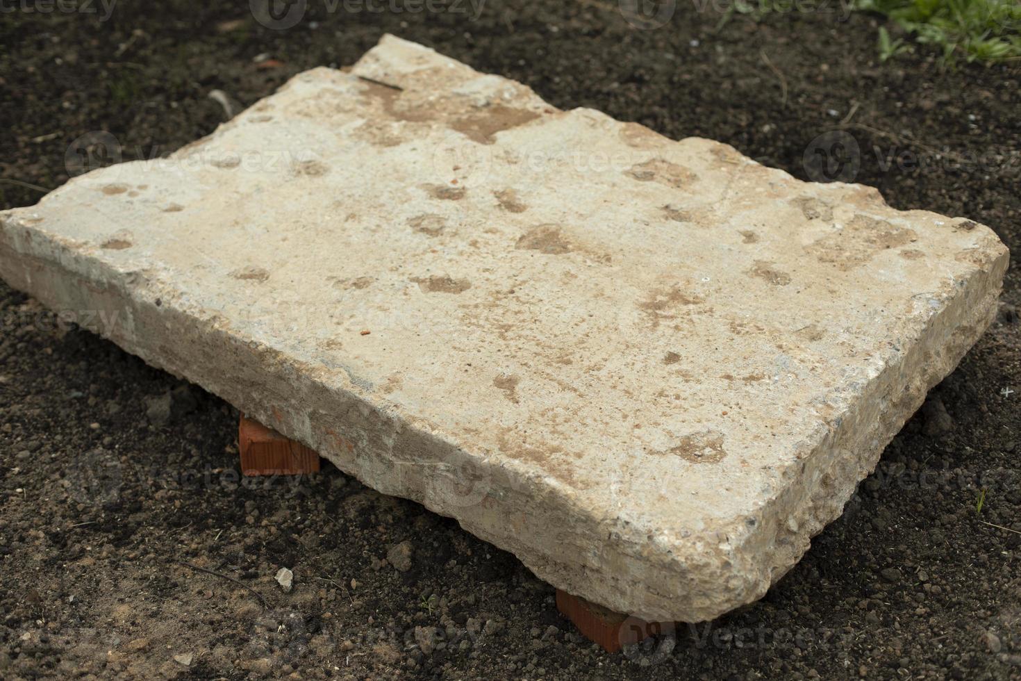 A large piece of concrete lying on the ground. Construction in Russia. photo