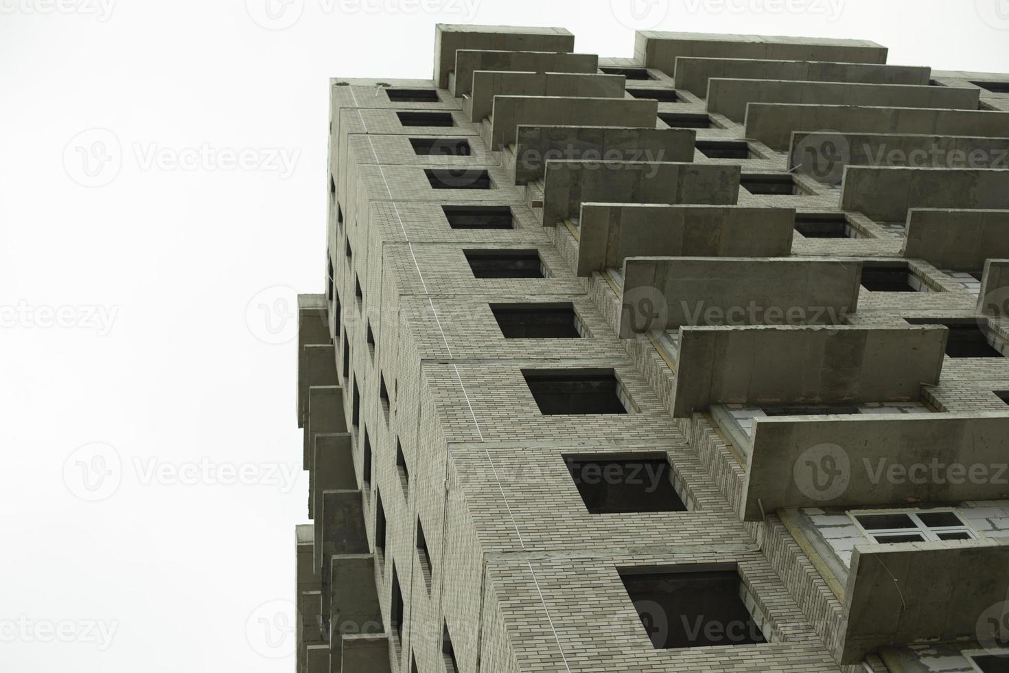 Windows of the house under construction. Construction of a building in the city. Construction of an apartment building. The building is unlined. photo