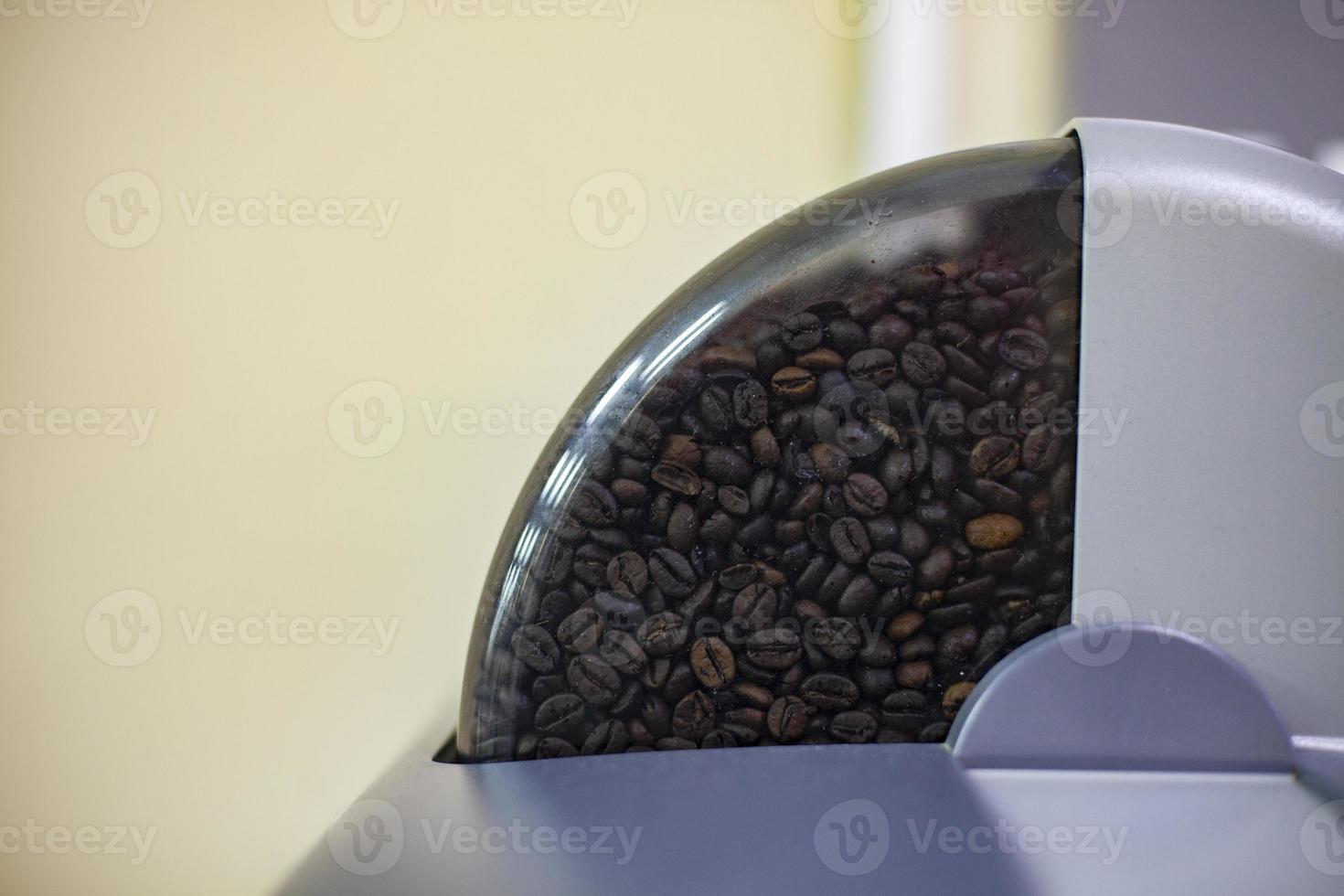 Coffee in the machine. Coffee beans in the office coffee machine. photo
