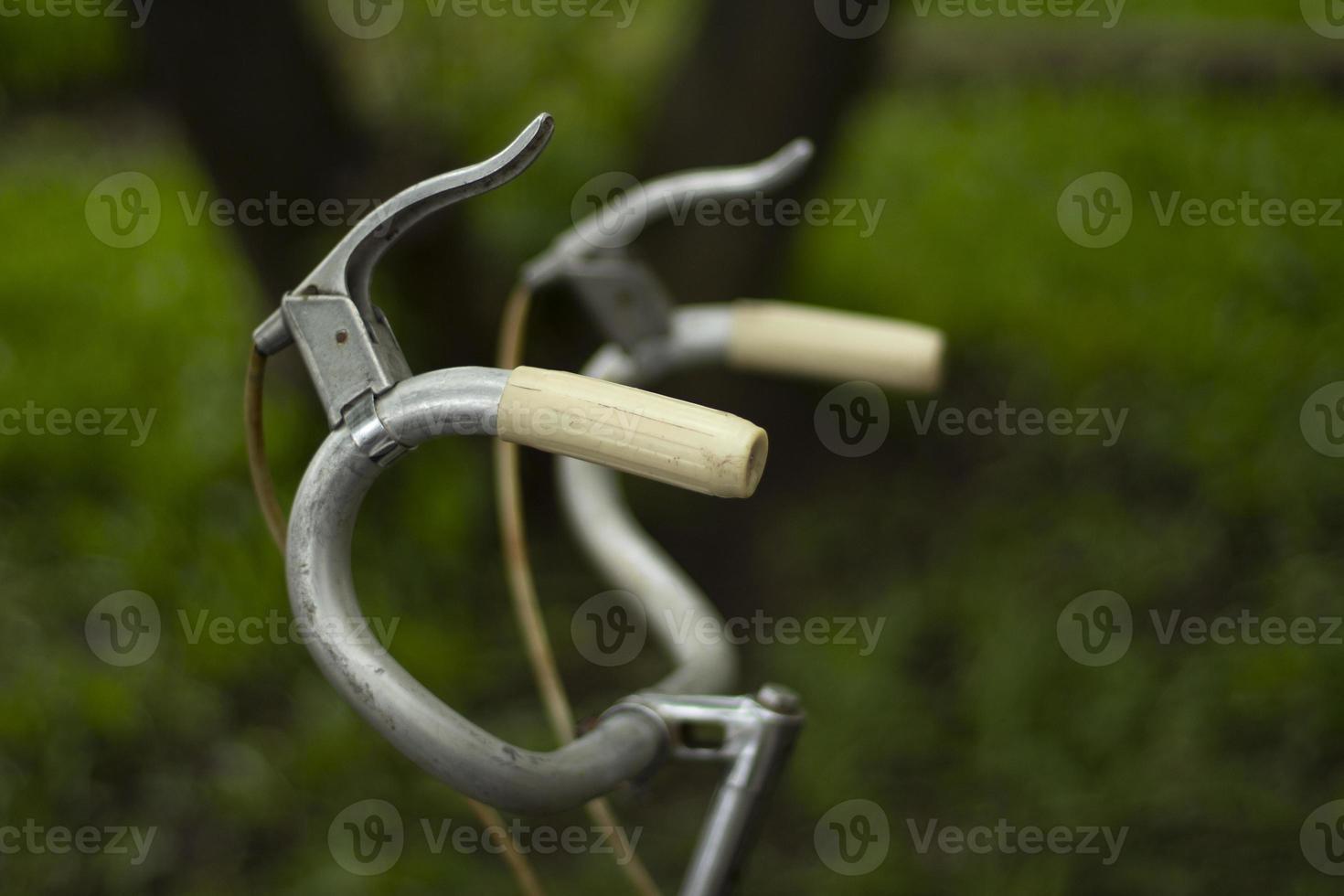 Old-fashioned steering wheel. Bicycle handlebars. Curved handles of an old bike. photo