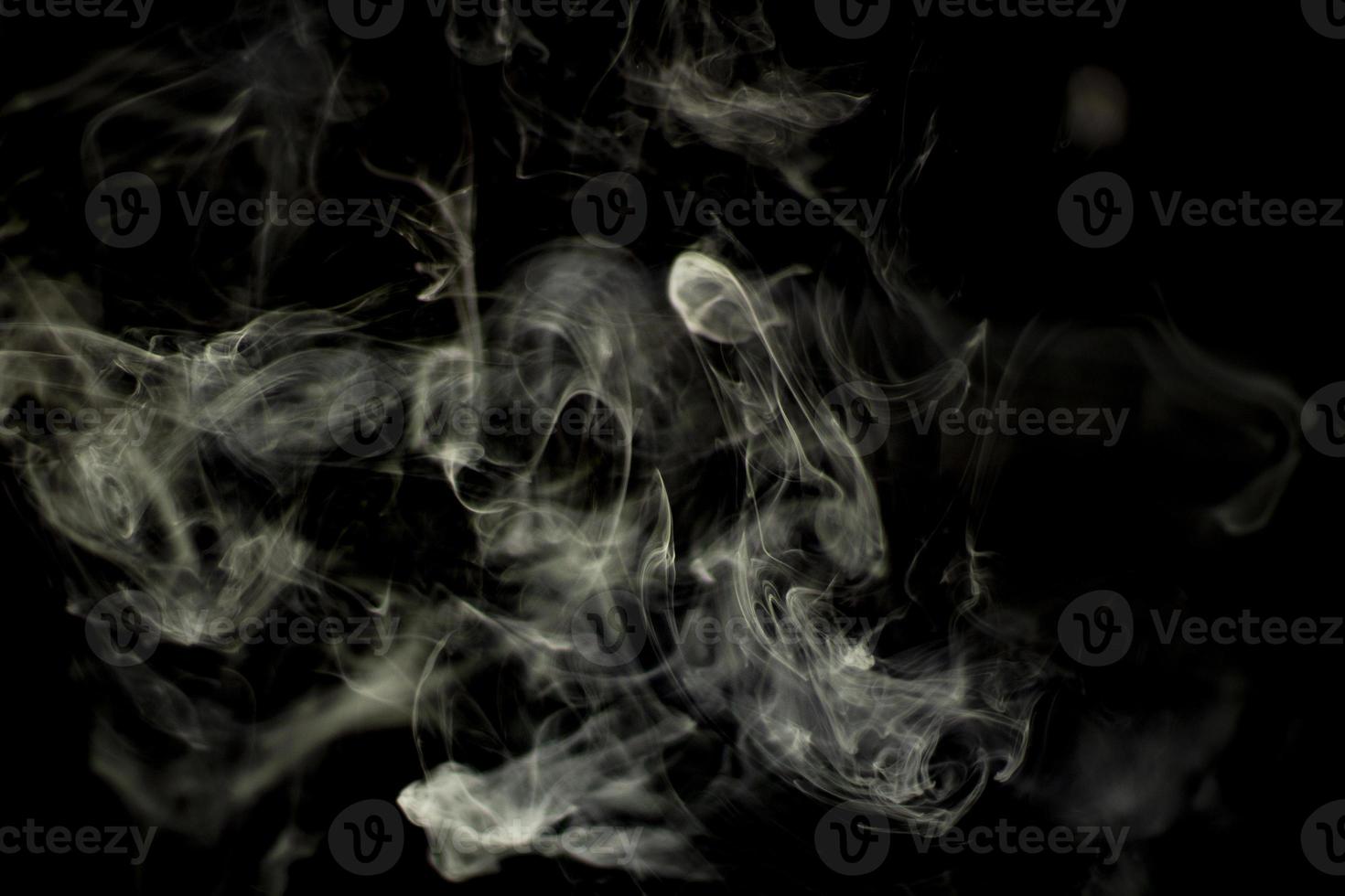 Smoke in natural light. Tobacco smoke fills the air. Clubs of steam in space. photo