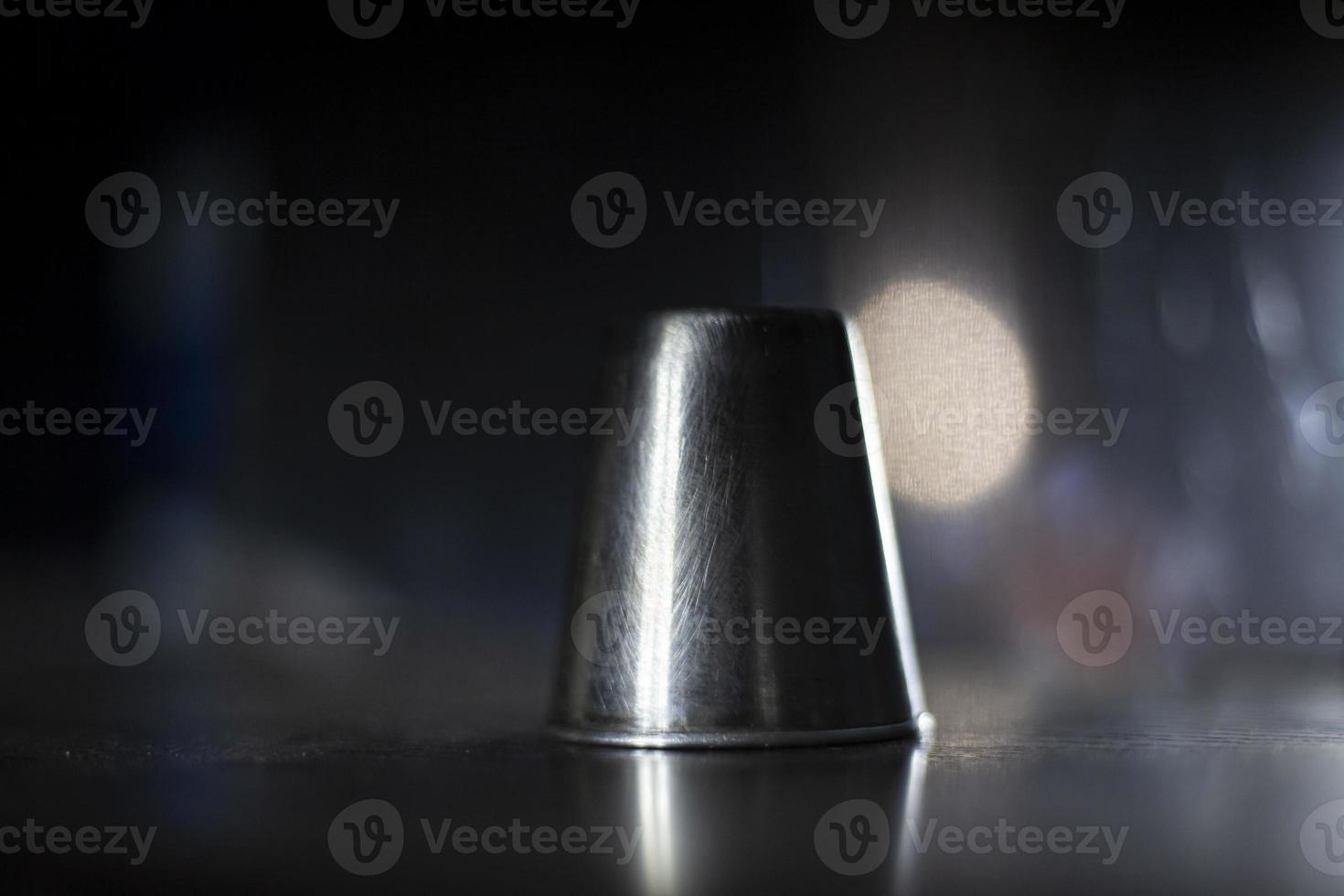 A stack for alcohol made of metal. Abstract background of metal and glass. Composition with the subject. The object in relation to the background. photo