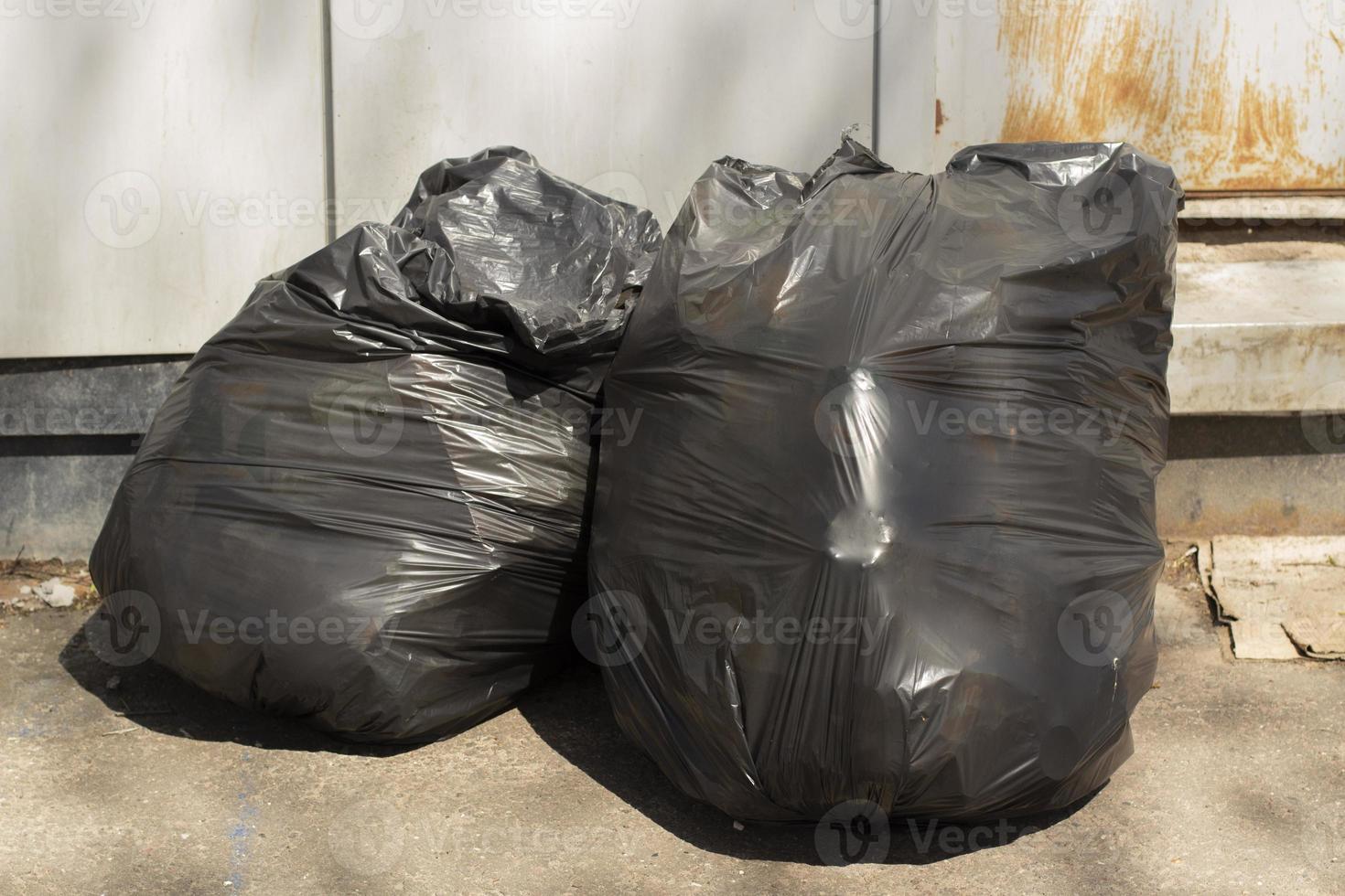 Garbage in bags. Black bags of waste. Plastic bags. photo