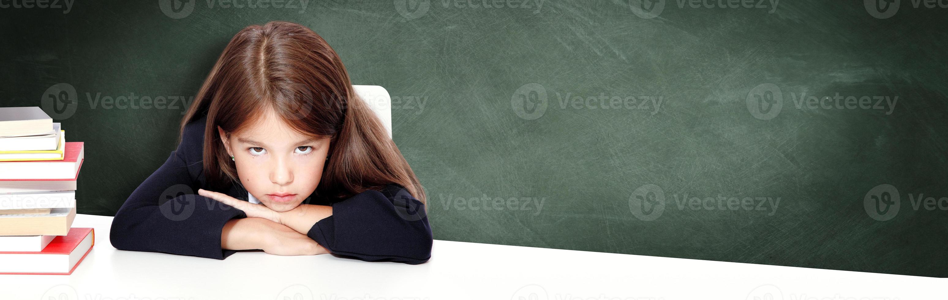 Frustrated and unhappy teen girl at school. photo