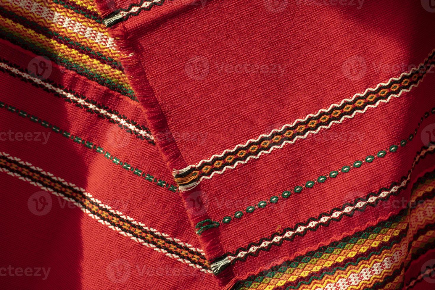 Red tablecloth in Russia. Folk pattern on the fabric. Fabric material in the Slavic peoples. photo
