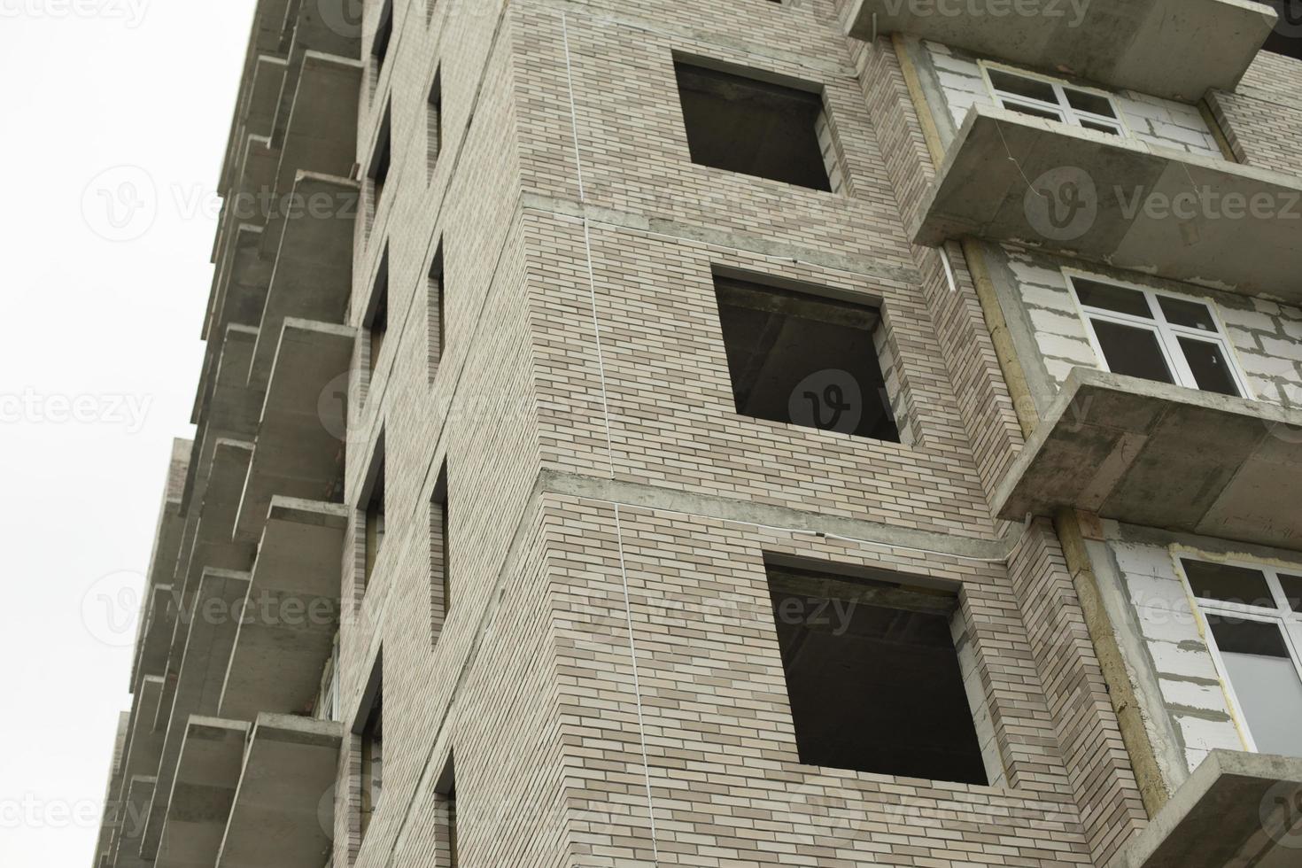 Windows of the house under construction. Construction of a building in the city. Construction of an apartment building. The building is unlined. photo