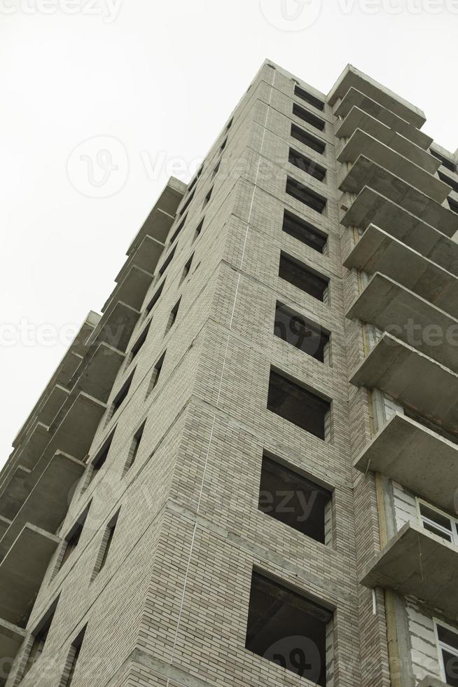 Windows of the house under construction. Construction of a building in the city. Construction of an apartment building. The building is unlined. photo