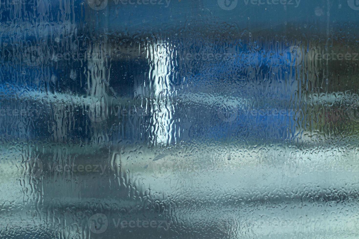 Blurred texture of transparent wet surface. Cold glass background. photo