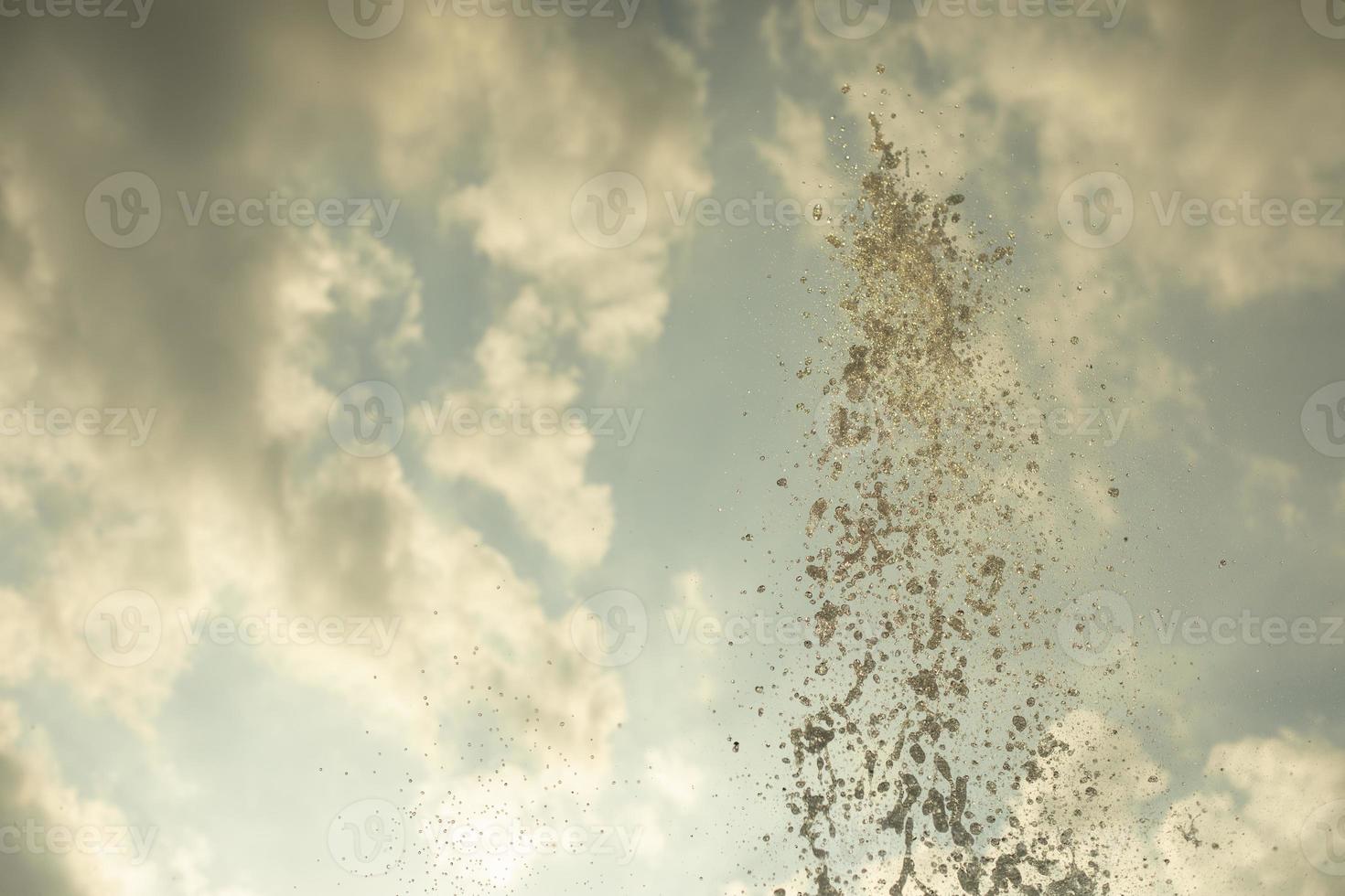 Jets of water against the sky. Splashes and drops from the fountain. photo