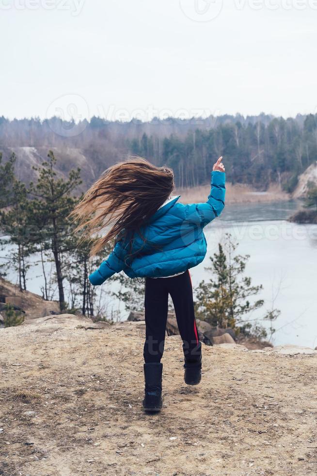 Young beautiful girl posing on a background of lake photo