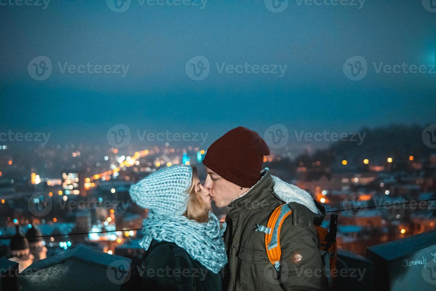 couple on the background of the cityscape at night photo