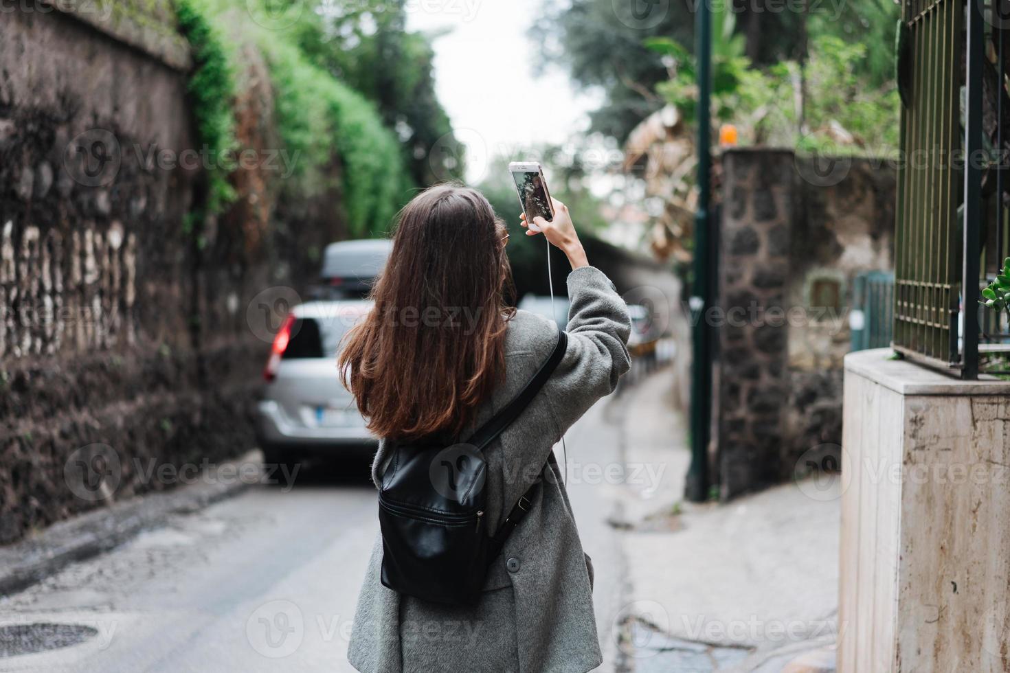 beautiful young girl takes photos on a smartphone