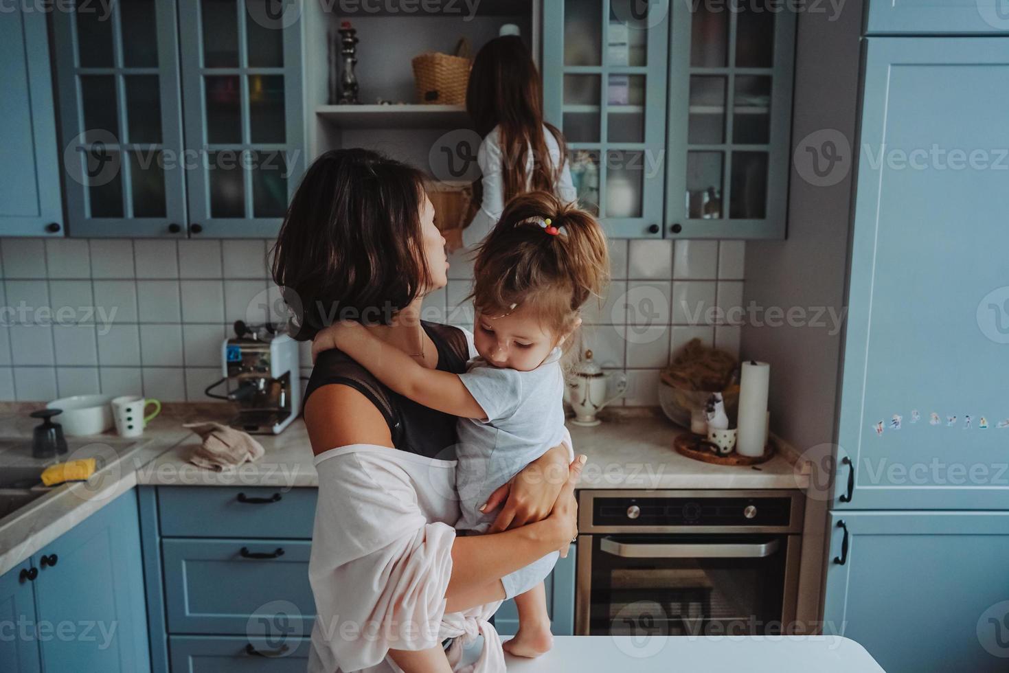 Happy family having fun in the kitchen photo