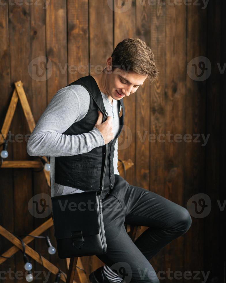 handsome guy with leather bag photo