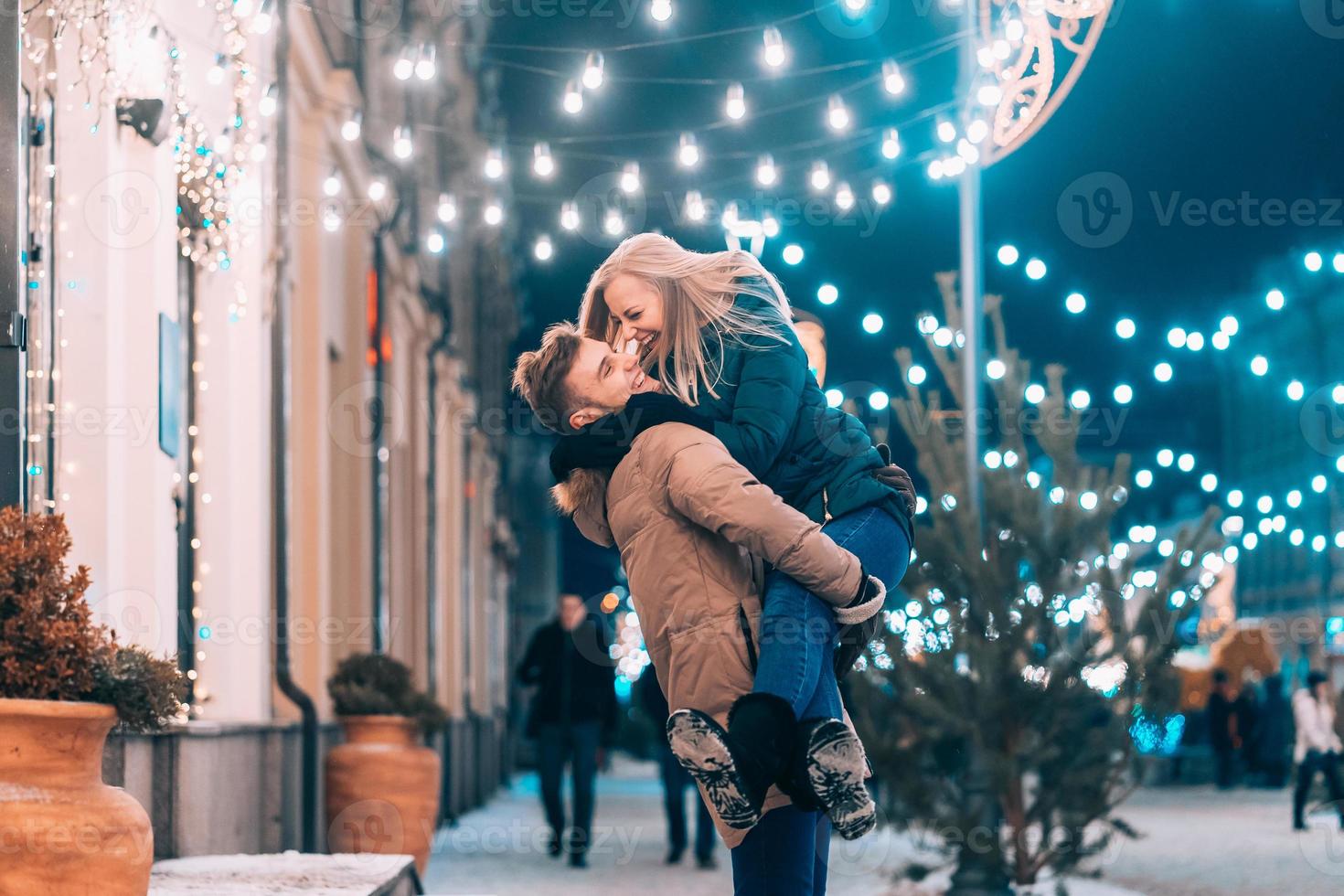 Outdoor close up portrait of young beautiful couple posing on street. photo