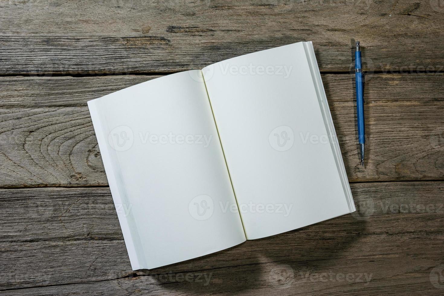 open note book with clutch-type pencil on wood background,,filter effect. photo