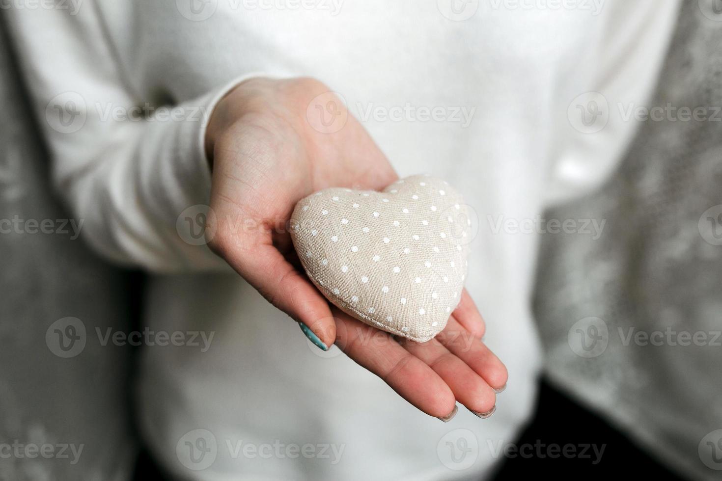 Girl holding a small lovely heart photo