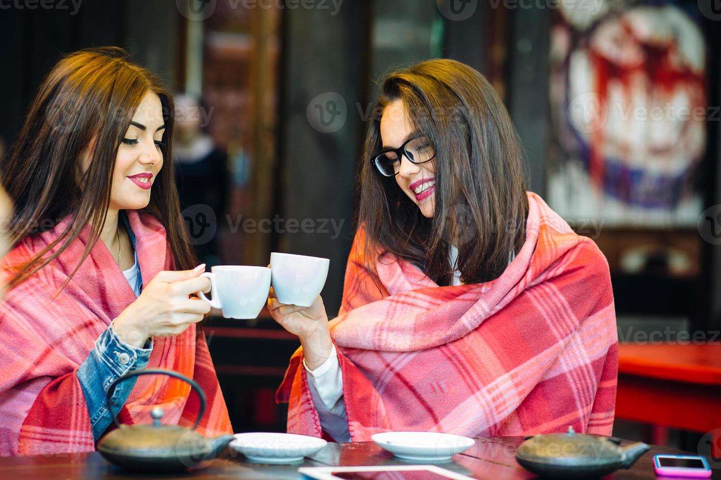 Two young and beautiful girls gossiping photo