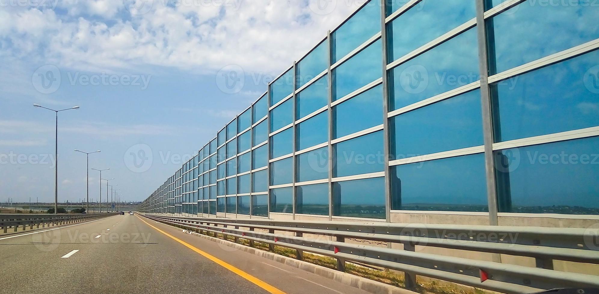 Modern architecture of the highway and the glass barrier photo