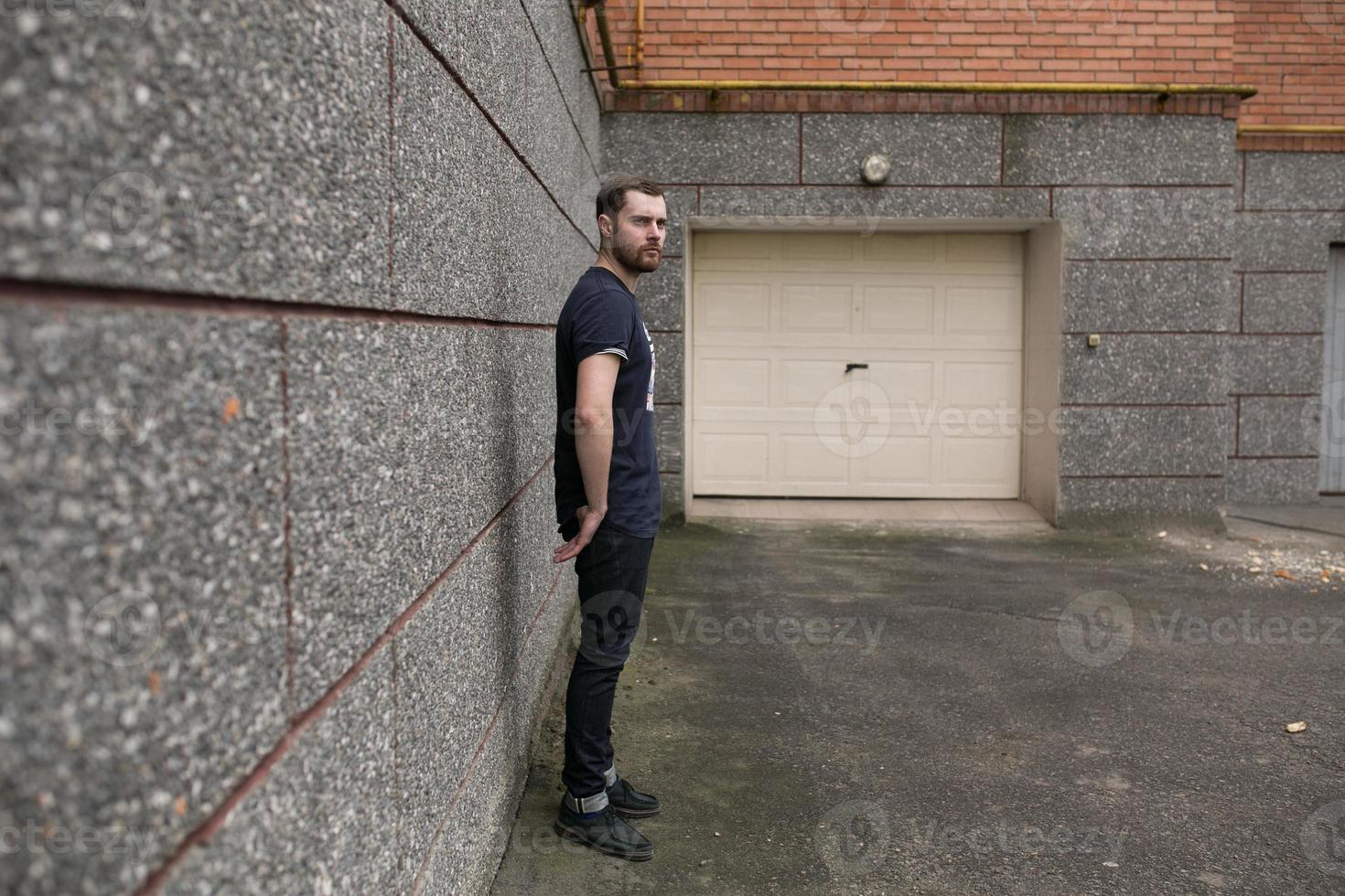 The man in the authentic boots and selvedge jeans  on a background of old city photo