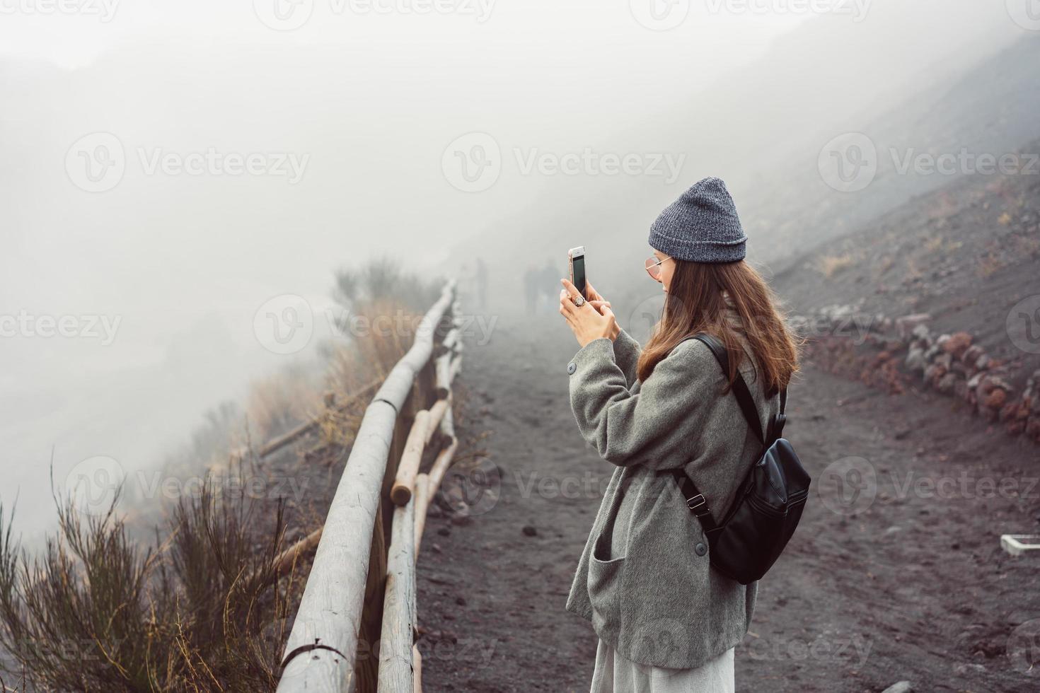 Girl climbs the path to the mountain photo