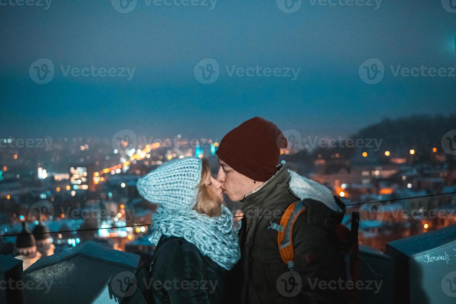 couple on the background of the cityscape at night photo