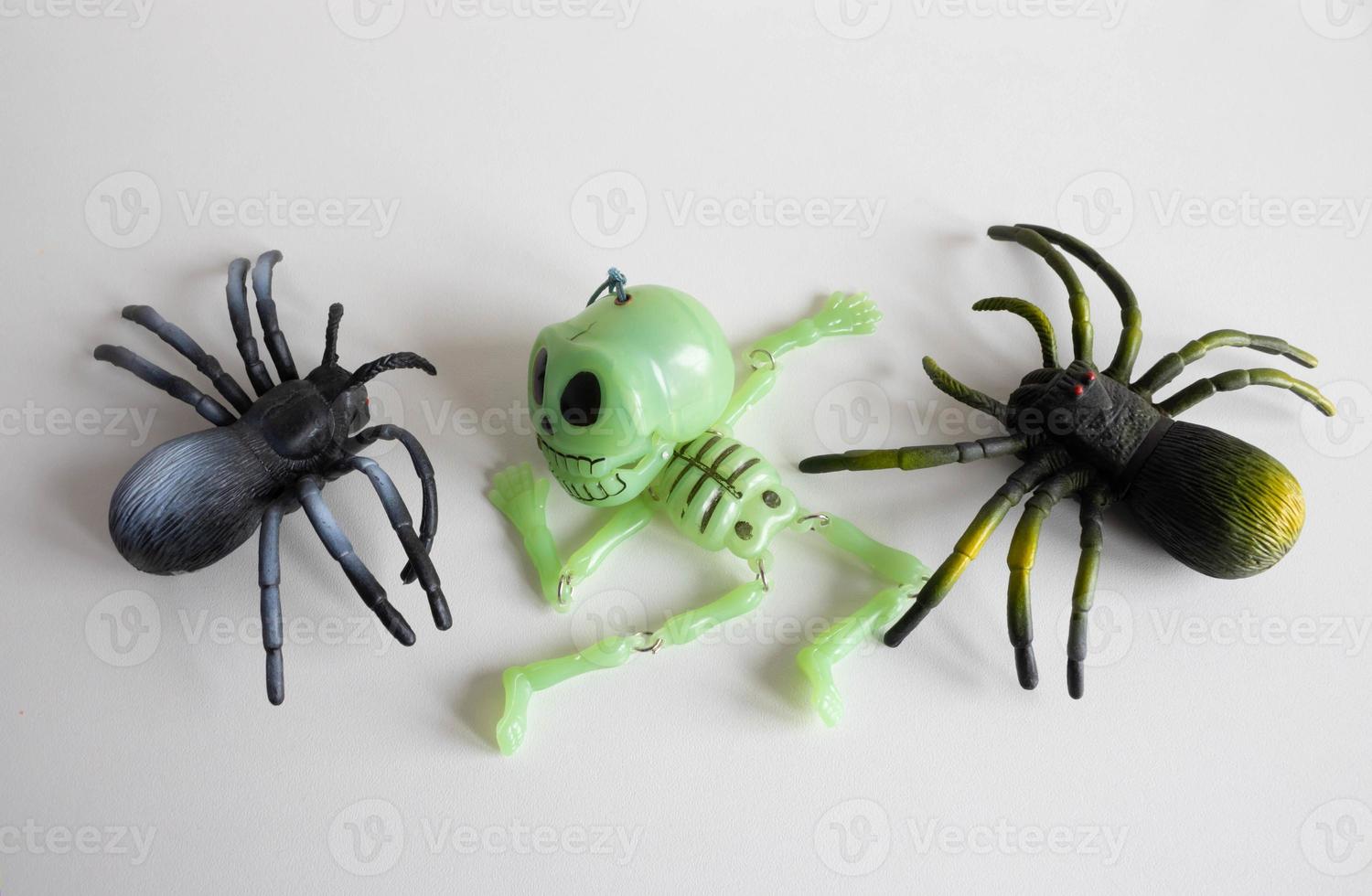 Halloween background with two spiders and a skeleton on a white background. Happy Halloween concept photo