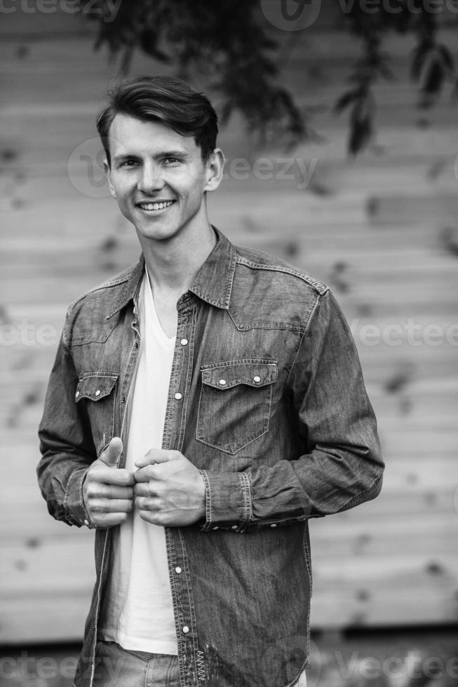young handsome man in a denim shirt photo