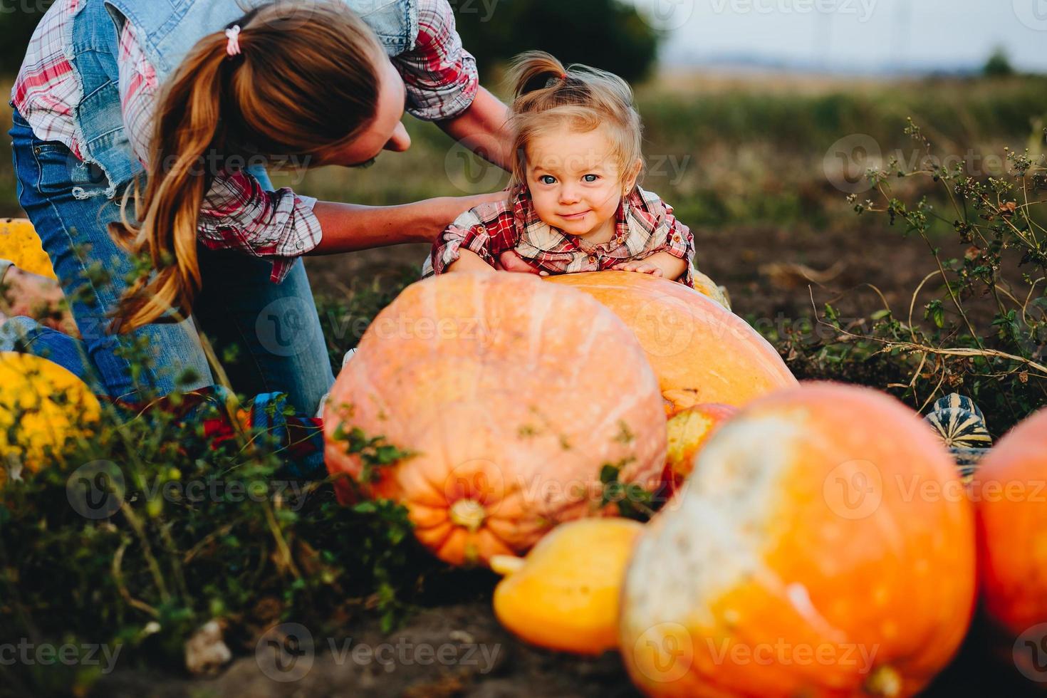 daughter lying on a pumpkin photo