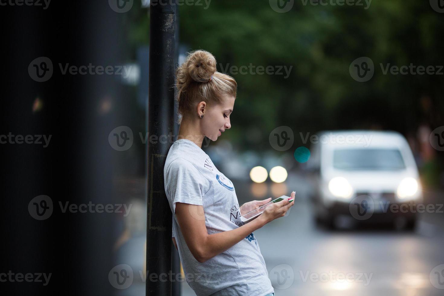 Cute girls with tablet on a bus station photo