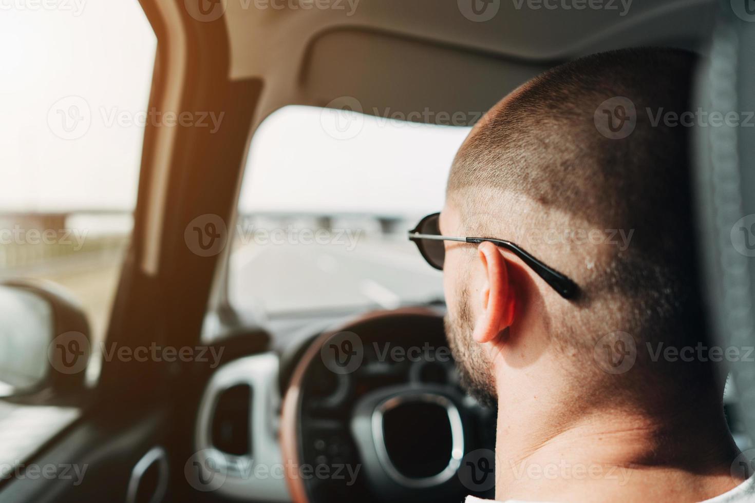 The man in the car traveling on the road photo