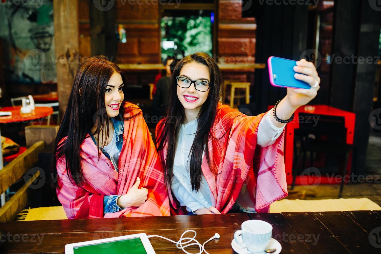 two close friends make selfie in the cafe photo