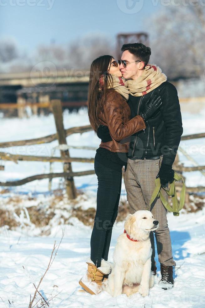 Young couple posing in winter park photo