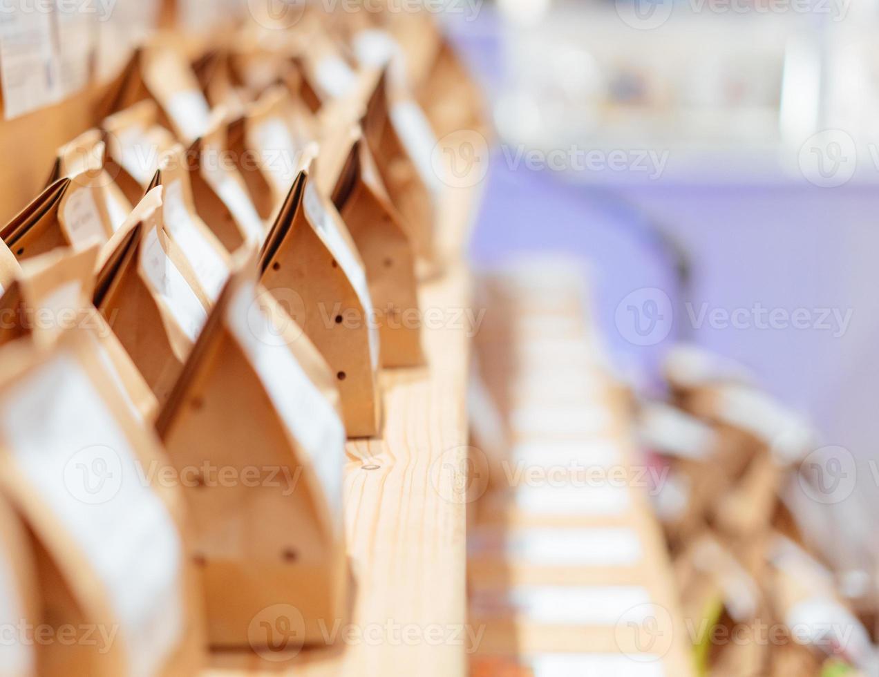 Brown paper food bag packages on wooden shelf photo