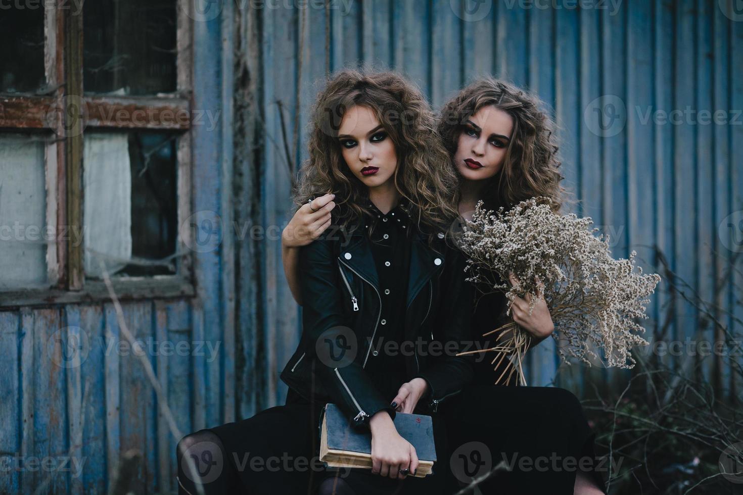 Two vintage witches gathered eve of Halloween photo