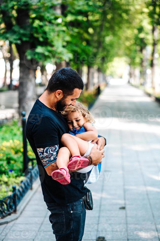 Cute little girl in her father's arm photo