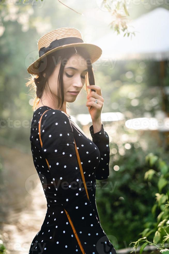 Girl in hat posing on camera photo