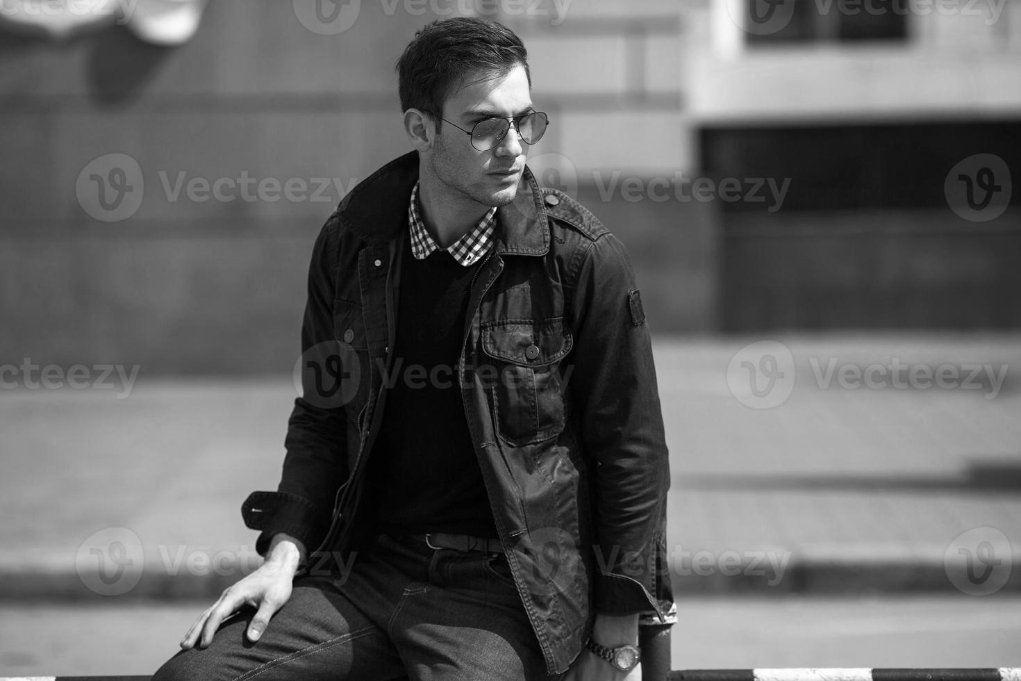 A man dressed in jeans on the background of the old city photo