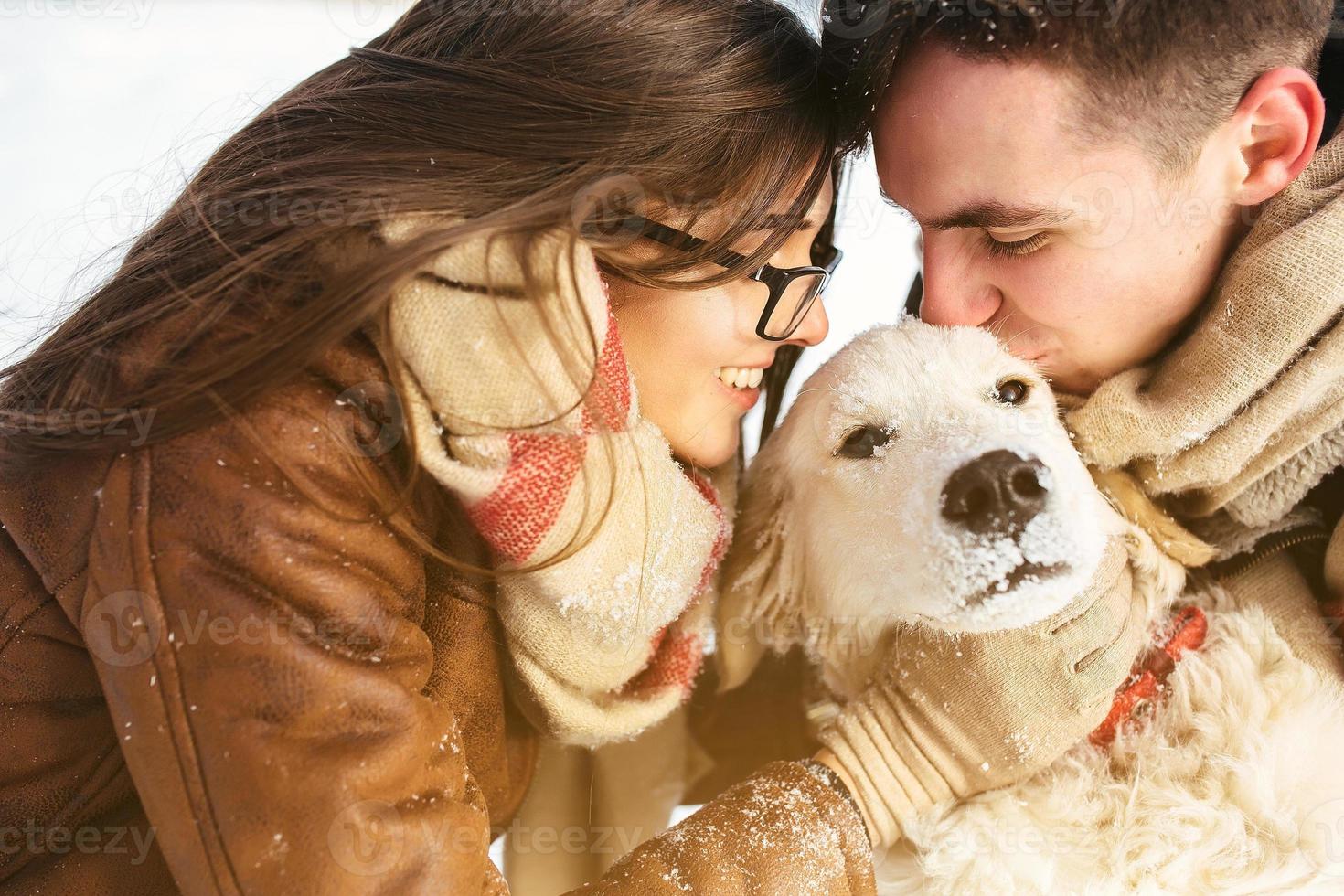 Young couple having fun in winter park photo