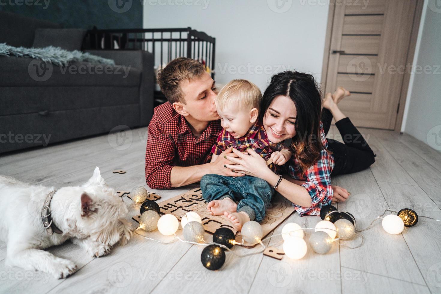 Happy family are playing together on the floor photo