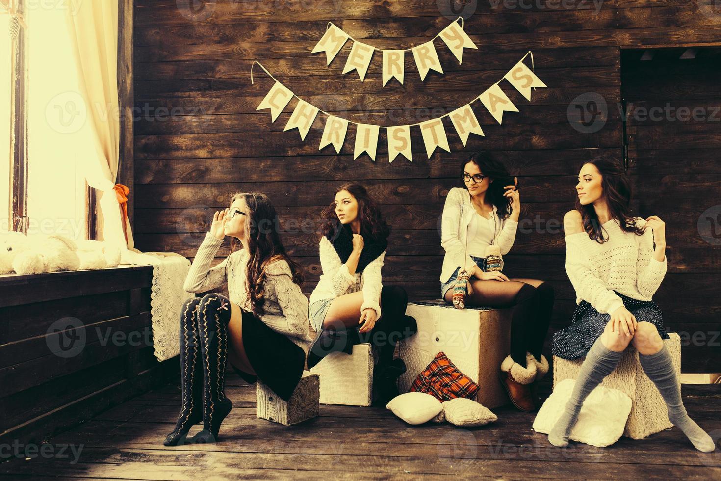 Four charming model posing on a vintage New Year's background photo