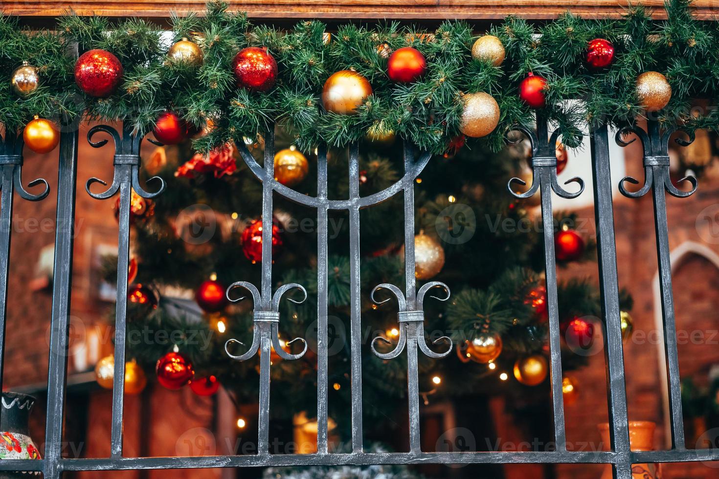 Christmas decoration lies on the forged railing. photo
