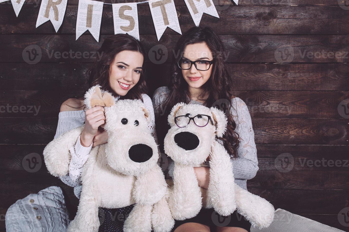 Two charming girls playing with Christmas toys photo