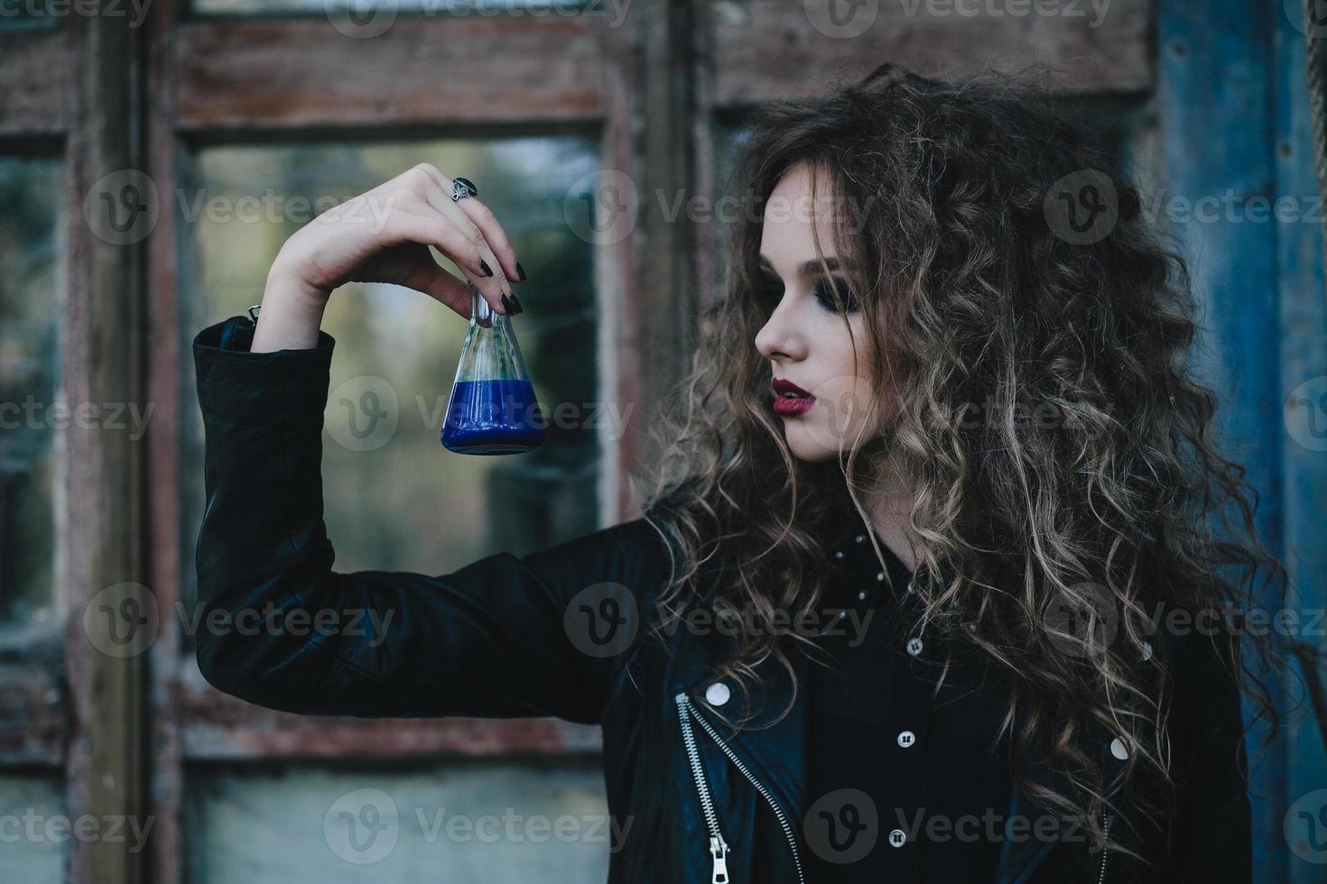Vintage witch with elixir in hand photo