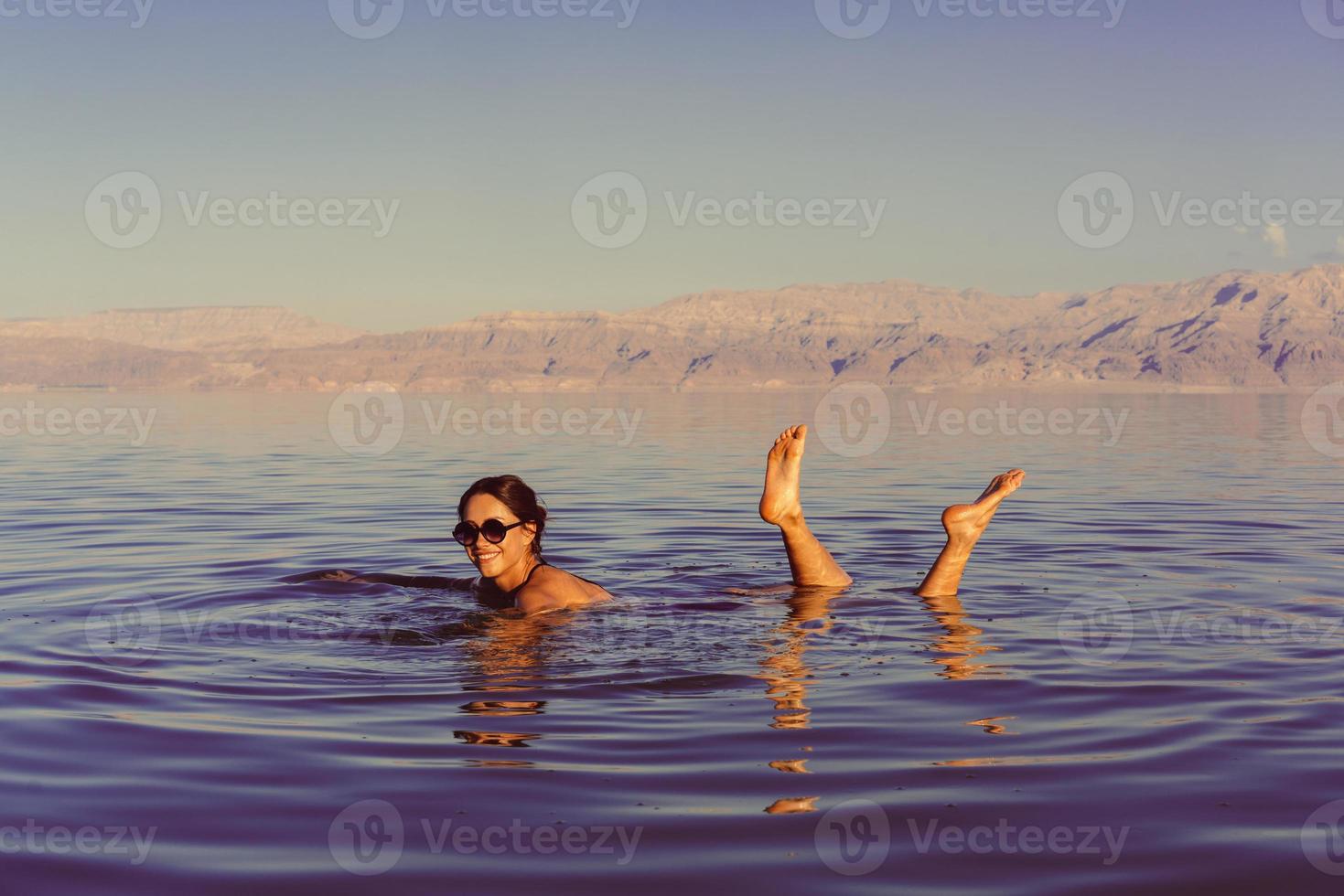 Girl is relaxing and swimming in the water photo