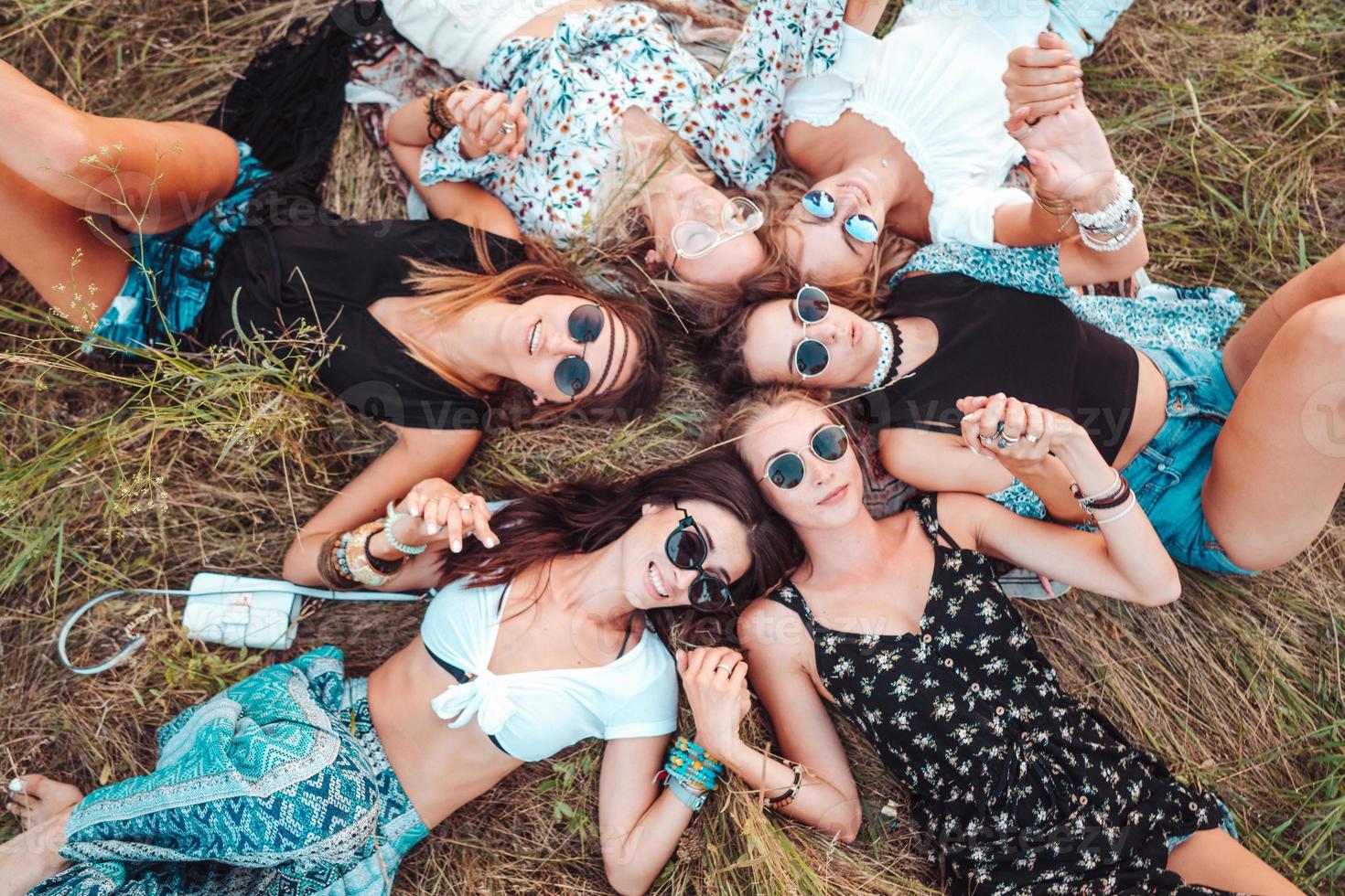 Six girls lie on the grass photo