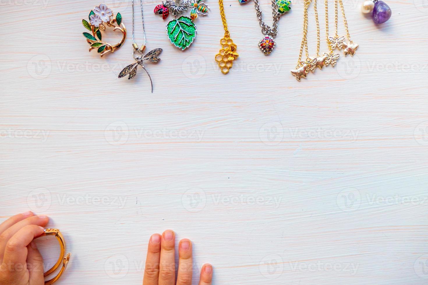 childrens hands play with light summer bijouterie, on white background. concept of womens happines. Copy space photo