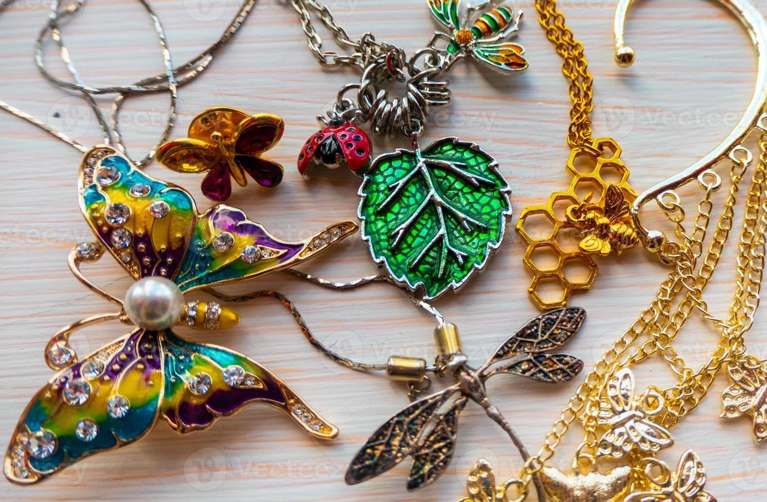 a lot of costume jewelry with different materials on a black background photo