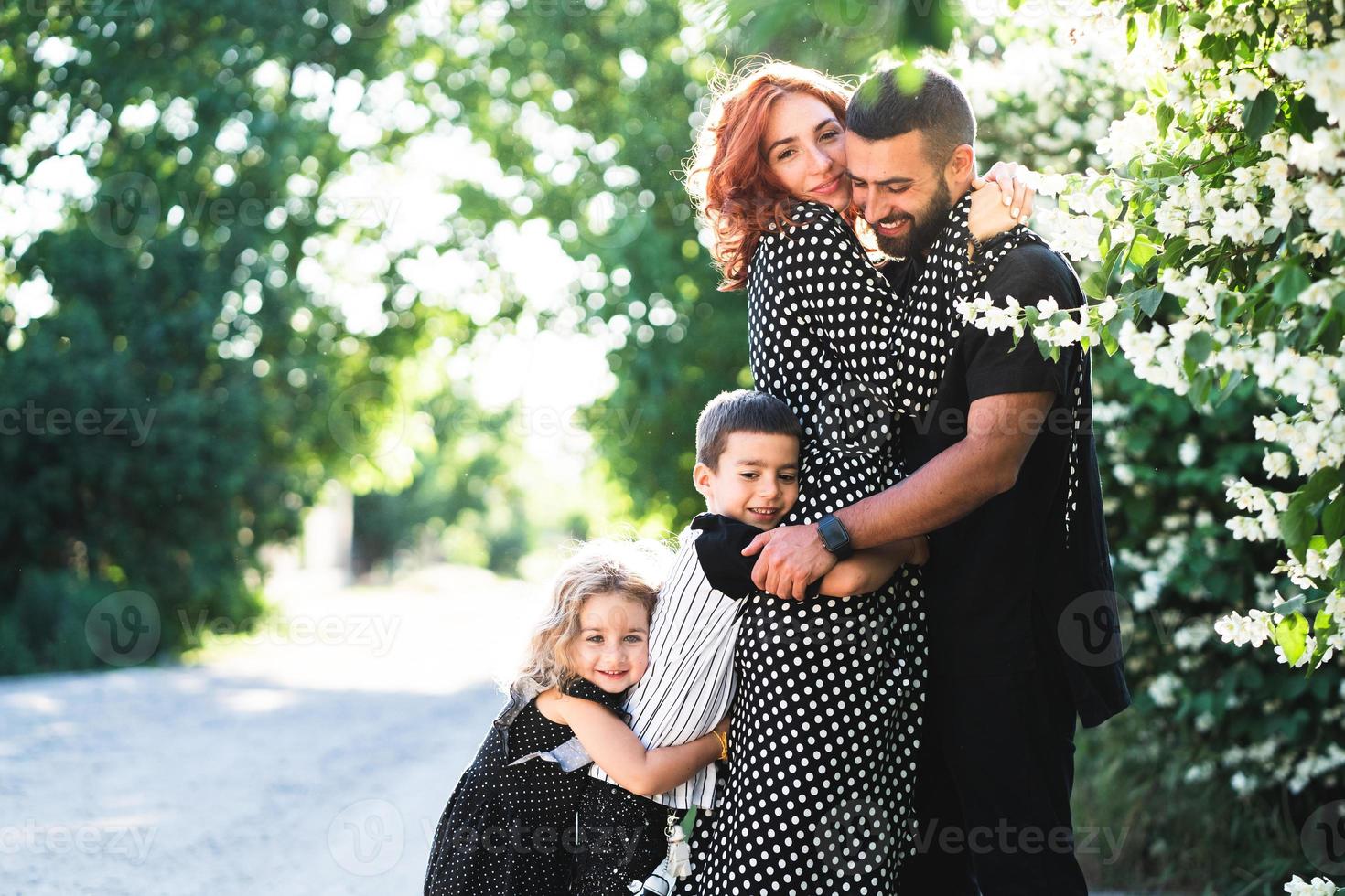 Mom, Dad, little son and daughter have fun photo