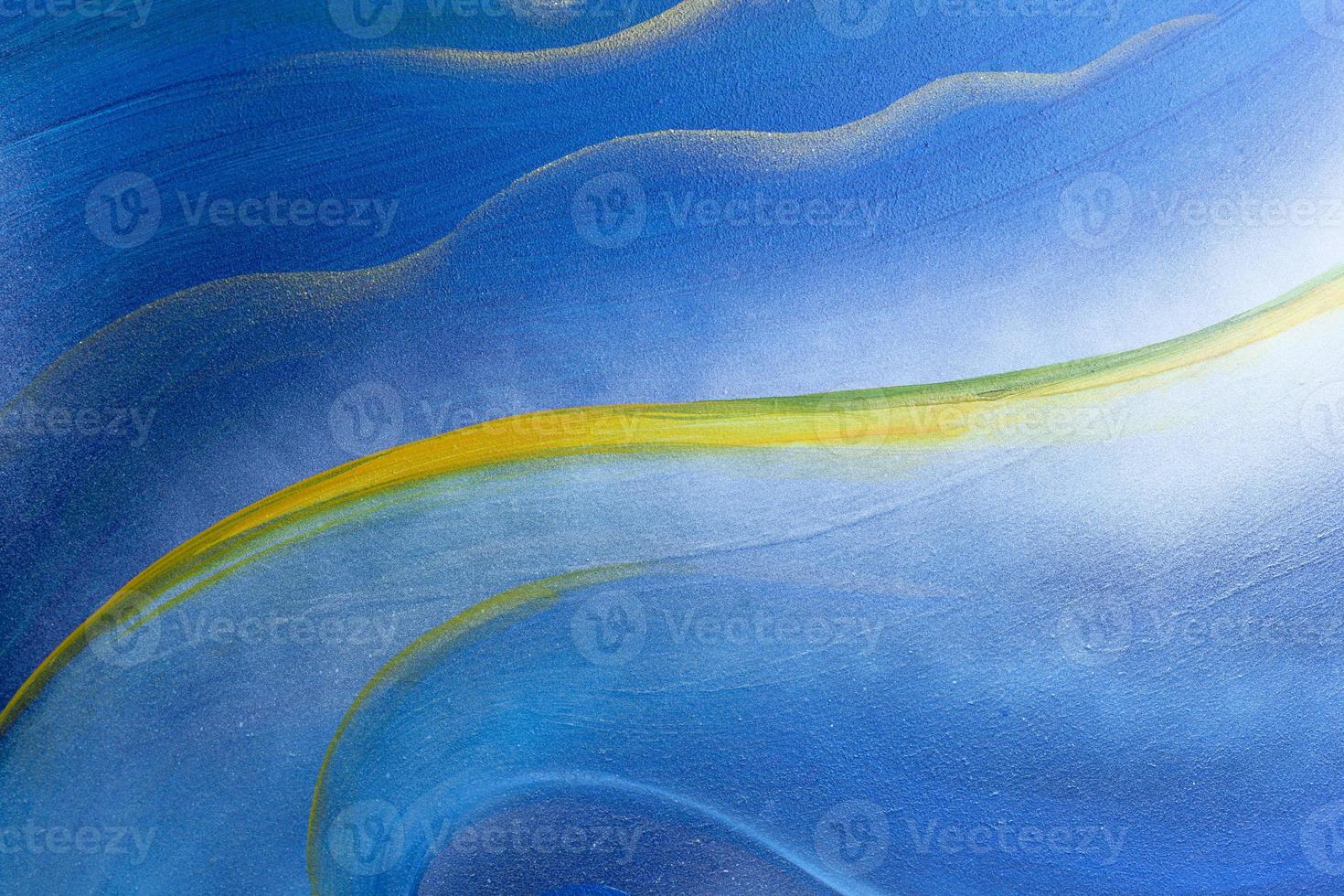 Abstract plaster wall background painted in blue and decorated with golden yellow curves. photo